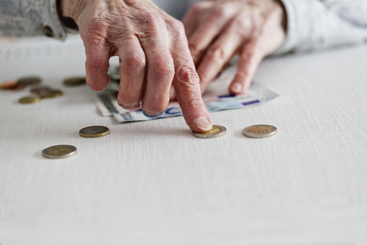 hands of senior adult counting money