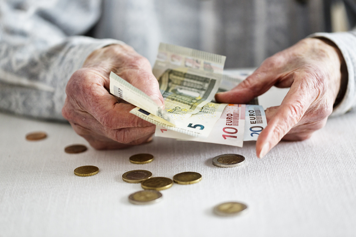 hands of senior adult counting money